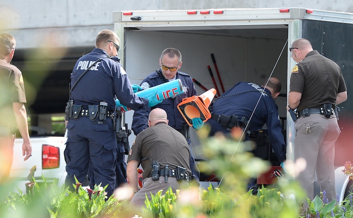 (Francisco Kjolseth  |  The Salt Lake Tribune)  Police gather evidence, including arm lock tubes with the words "ABOLISH ICE" after activists staged a protest against a private prison company with contracts to hold undocumented immigrants on Thursday, July 12, 2018, at the headquarters of Management and Training Corporation in Centerville.