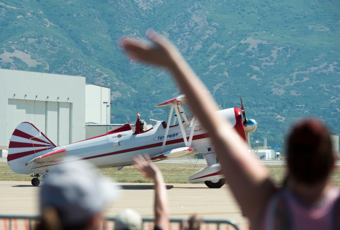 (Rick Egan  |  The Salt Lake Tribune)    Gary Rower waves to the crowd as he lands in his 1941 Stearman, at the Warriors Over the Wasatch airshow at Hill Airforce Base, Sunday, June 24, 2018.