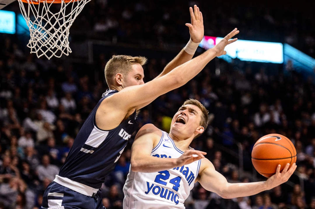 (Trent Nelson | The Salt Lake Tribune)  Brigham Young Cougars guard McKay Cannon (24) shoots, defended by Utah State Aggies guard Sam Merrill (5) as BYU hosts Utah State, NCAA basketball in Provo on Wednesday Dec. 5, 2018.