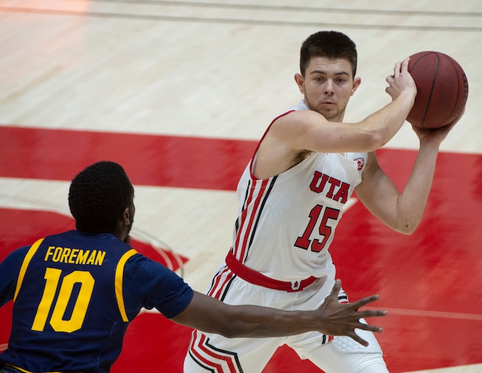 (Rick Egan | The Salt Lake Tribune)  Utah Utes guard Rylan Jones (15) works the ball as California Golden Bears guard Makale Foreman (10) defends, in PAC12 Basketball action between the Utah Utes and the California Golden Bears, on Wednesday, Jan. 16, 2021.