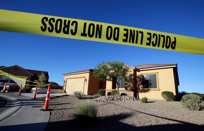 Police tape blocks off the home of Stephen Craig Paddock on Monday, Oct. 2, 2017, in Mesquite, Nev. Paddock killed dozens and injured hundreds on Sunday night when he opened fire at an outdoor country music festival in Las Vegas. Heavily armed police searched Paddock's home Monday. (AP Photo/Chris Carlson)