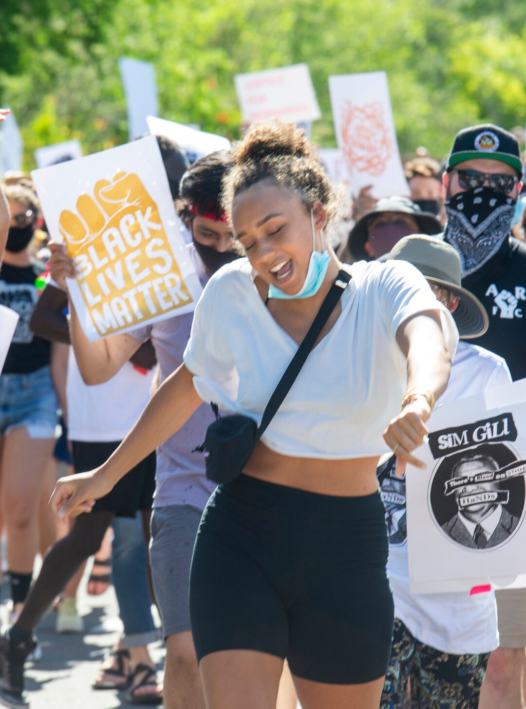 (Rick Egan  |  The Salt Lake Tribune)     Bella Swan sings as she dances to Aretha Franklin, as protesters dance on Football drive during a march for Justice onSunday, July 12, 2020.