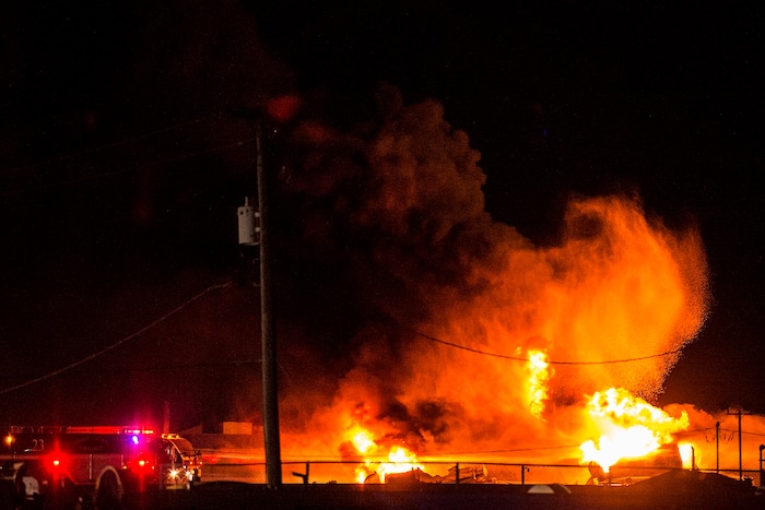 (Chris Detrick  |  The Salt Lake Tribune)  Firefighters attempt to put out a burning semitrailer that was hauling thousands of gallons of fuel on Interstate-15 in Midvale Thursday, January 18, 2018.   Lt. Todd Royce of the Utah Highway Patrol said the truck was southbound on the interstate at 7500 South at 7:20 p.m. when a tire caught fire, sending flames toward the tanks.