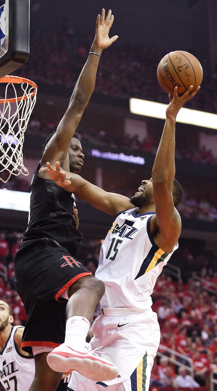 Utah Jazz forward Derrick Favors (15) shoots as Houston Rockets center Clint Capela defends during the second half in Game 2 of an NBA basketball second-round playoff series Wednesday, May 2, 2018, in Houston. (AP Photo/Eric Christian Smith)