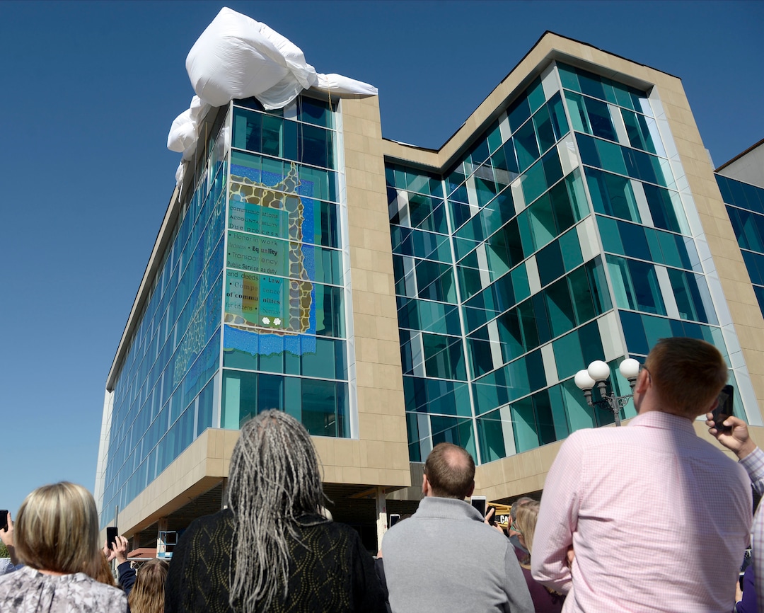 (Al Hartmann  |  The Salt Lake Tribune) 	Crowd gathers for the unveiling of the new glass art covering the façade of the downtown District Attorney building at 35 E. 500 S. in Salt Lake City September 27, 2017.   The glass artwork is complete, but the building is currently under construction to be completed in Spring 2018.  
