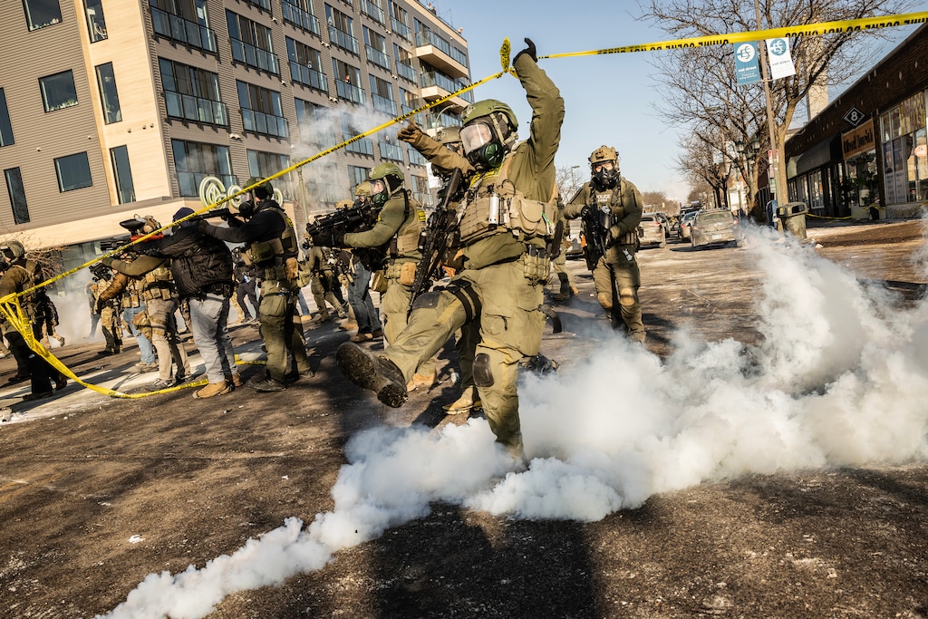 (David Guttenfelder | The New York Times) Federal agents deploy tear gas as they confront protestors in Minneapolis where federal law enforcement agents shot a person earlier on Saturday, Jan. 24, 2026.