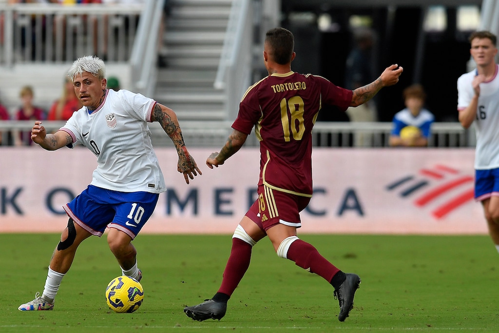 (Michael Laughlin | AP) United States midfielder Diego Luna (10) tries to dribble around Venezuela midfielder Edson Tortolero (18) during the second half of an international friendly soccer game, Saturday, Jan 18, 2025, in Fort Lauderdale, Fla.