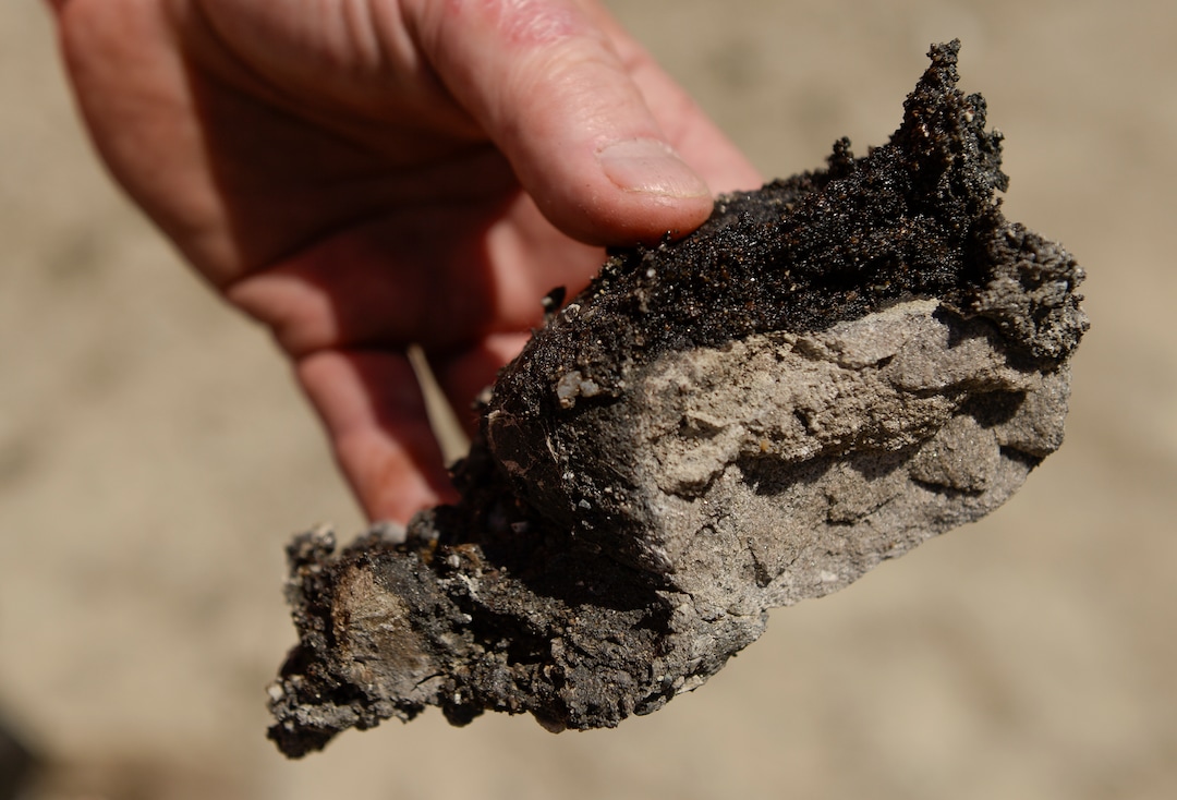 Leah Hogsten  |  The Salt Lake Tribune   ÒBy crushing it down so small you are increasing the surface area of the oil sands for the solvent to extract the bitumen," said Donald Clark , geologist with Petroteq Energy, Thursday, June 14, 2018 while holding a large piece of tar sands from the company's Uinta Basin quarry along Asphalt Ridge. The bitumen soaked sand lies close to the surface in rich 50-foot seams. The ore averages 12 percent oil.
