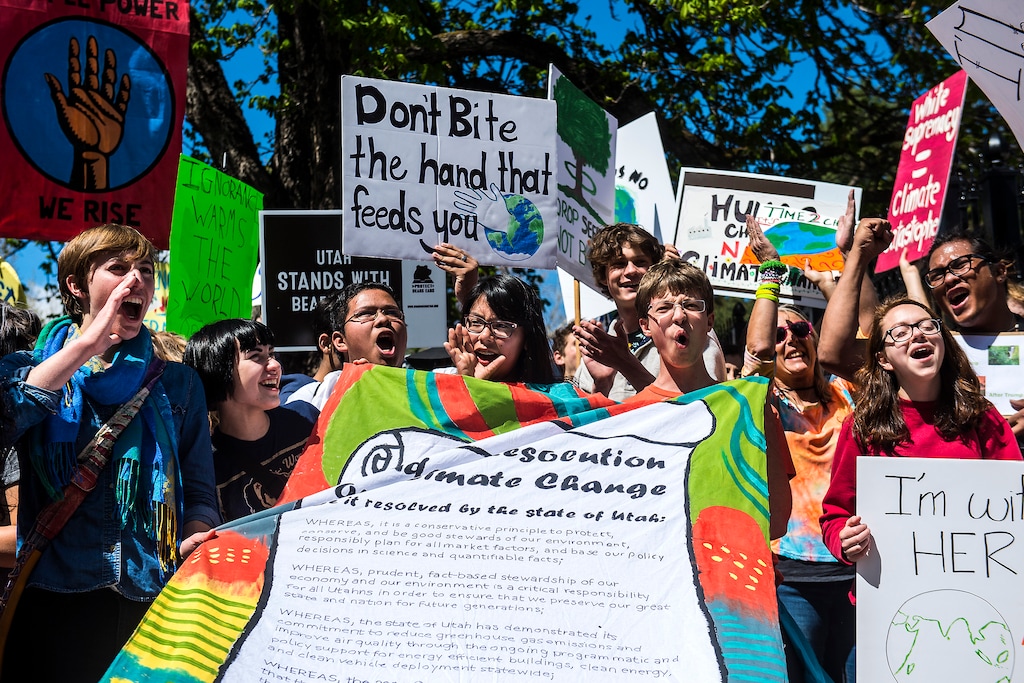 (Chris Detrick  |  The Salt Lake Tribune) Participants rally while holding their 'Student Resolution on Climate Change the Governor's Mansion during the Utah People's Climate March Saturday, April 29, 2017.