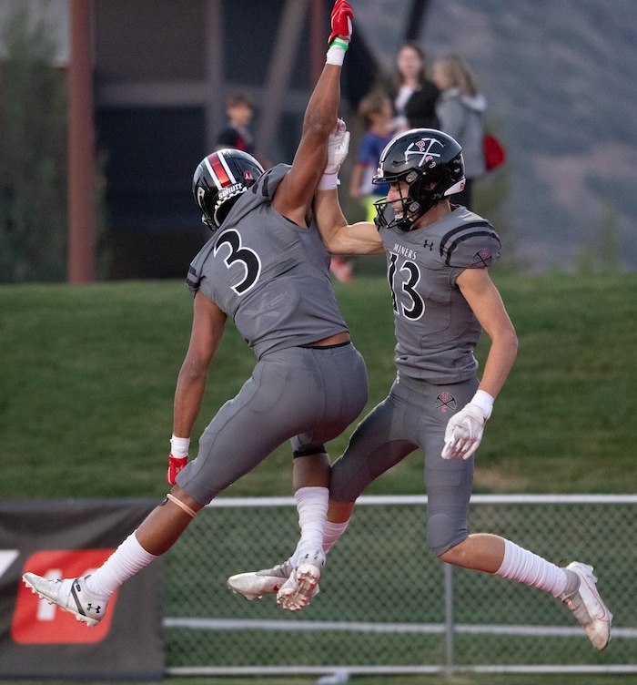(Francisco Kjolseth | The Salt Lake Tribune) Sam Alford (3) celebrates a touchdown by teammate Joseph Eldridge (13) In prep football action between Park City Miners and the East Leopards on Friday, Sept. 3, 2021.