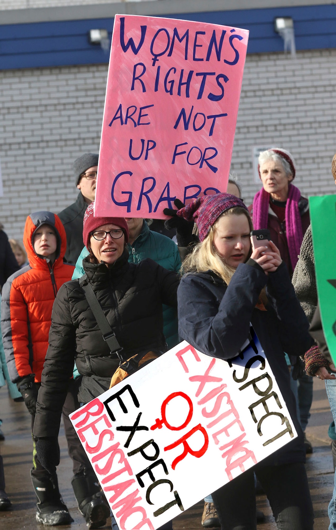 Hundreds march Saturday, Jan. 20, 2018 through downtown Eau Claire, Wis. as part of the Women's March Wisconsin Day of Action. The march followed a rally at Phoenix Park and was a companion event to marches in Milwaukee and Green Bay. (Steve Kinderman/The Eau Claire Leader-Telegram via AP)