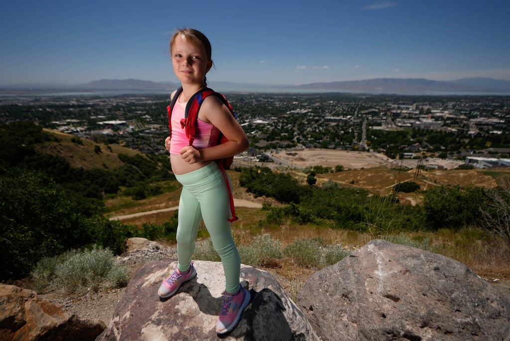 (Francisco Kjolseth | The Salt Lake Tribune) Sadie Mortensen, who at age 5 first set her sights on hiking the Y above BYU. She finally made it at age 7, a couple weeks back, carrying her own water and having triumphed over the leukemia that sent bolts of pain down her leg. Sadie revisited the trailhead on Thursday, June 20, 2024, with hopes for many more adventures ahead.