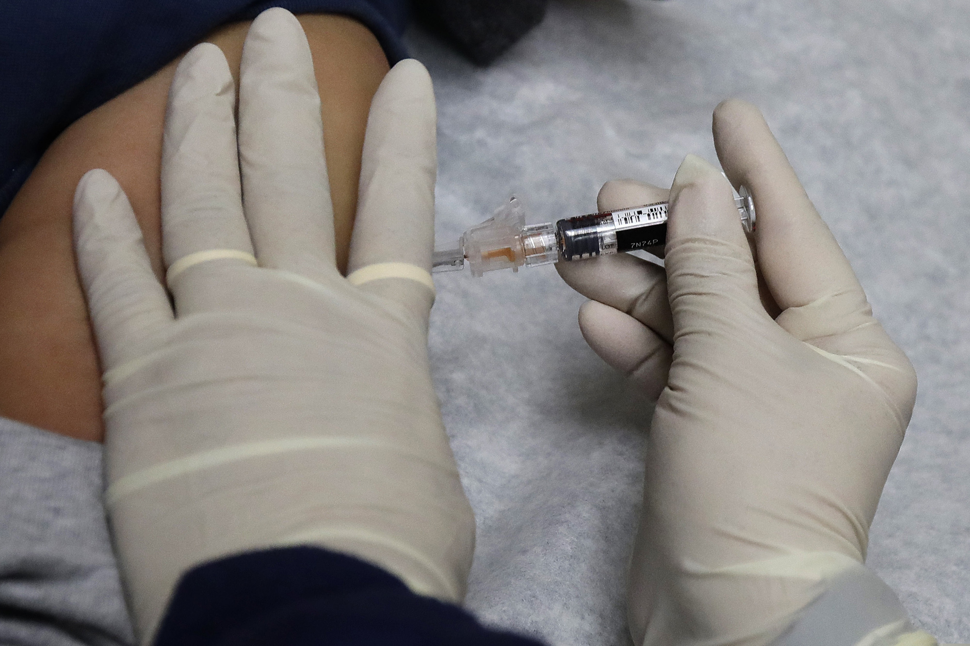 (Ted S. Warren | AP file photo)  A medical assistant at a community health center gives a patient a flu shot in Seattle in January 2018.