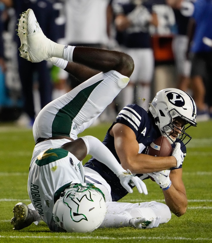 (Francisco Kjolseth | The Salt Lake Tribune) Brigham Young Cougars wide receiver Gunner Romney (18) pulls in a long pass as he’s pressured by South Florida Bulls defensive back TJ Robinson (2) in game action between the Brigham Young Cougars and the South Florida Bulls at LaVell Edwards Stadium in Provo, Saturday, Sept. 25, 2021.