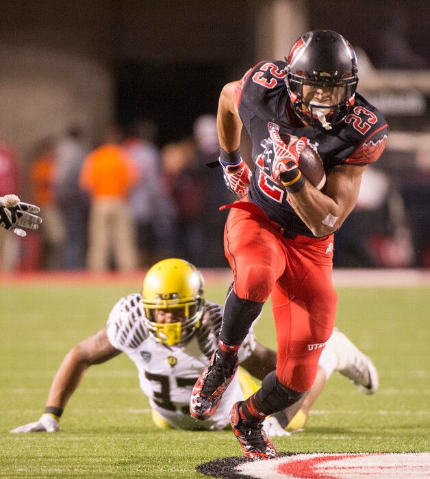 Rick Egan  |  The Salt Lake TribuneOregon Ducks linebacker Tyson Coleman (33) watches as Ute running back Devontae Booker (23) runs the ball into the end zone for a touchdown, in Pac-12 football action, Utah vs. Oregon game, at Rice-Eccles Stadium, Saturday, November 8, 2014