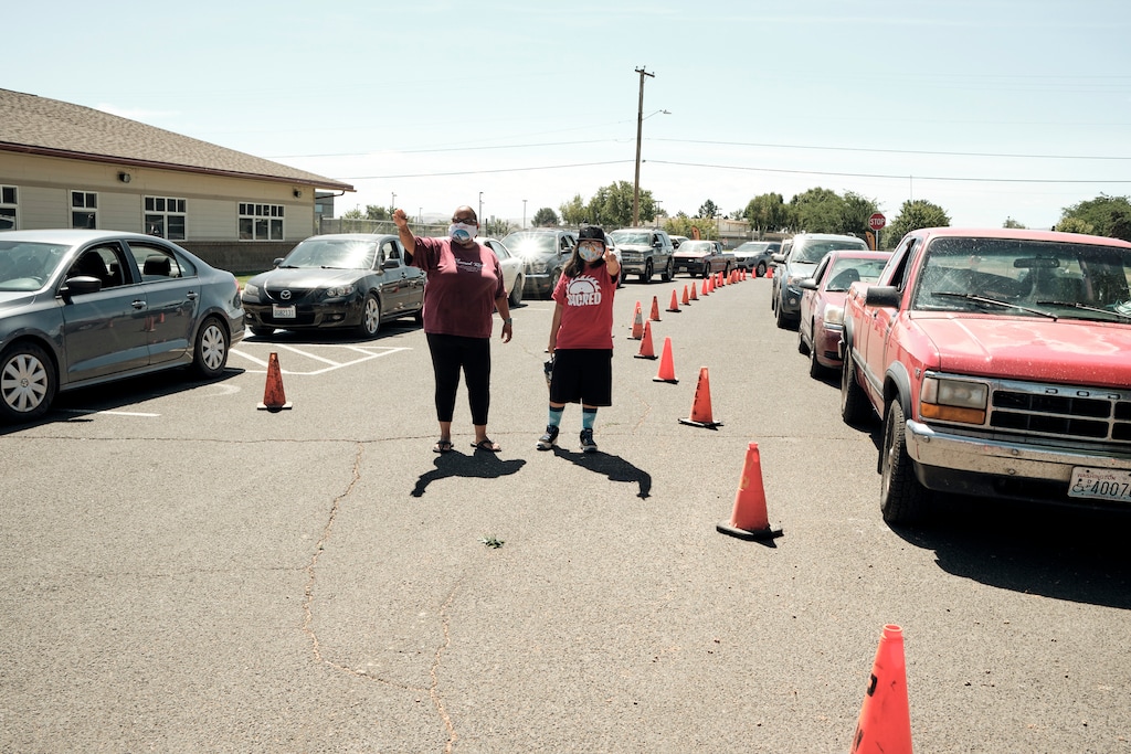 (Mason Trinca | The New York Times) Cars lined up for the Peacekeeper Society's weekly food giveaway at the Wapato Community Center in Wapato, Wash., July 17, 2020. Even with significant gaps in the data that is available, there are strong indications that Native American people have been disproportionately affected by the coronavirus.