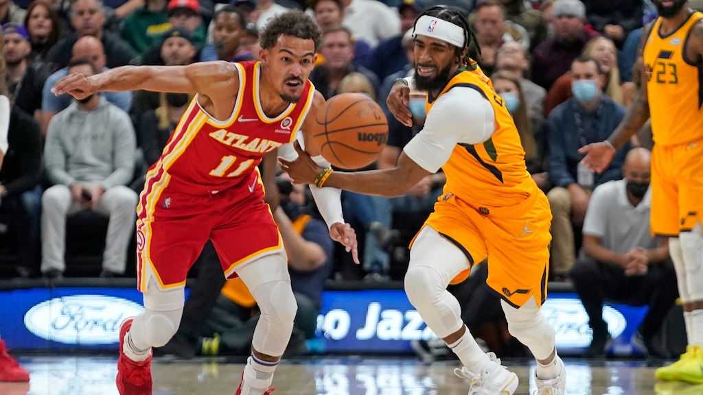 Atlanta Hawks guard Trae Young (11) battles for a loose ball with Utah Jazz guard Mike Conley (11) in the first half during an NBA basketball game Tuesday, Nov. 9, 2021, in Salt Lake City. (AP Photo/Rick Bowmer)