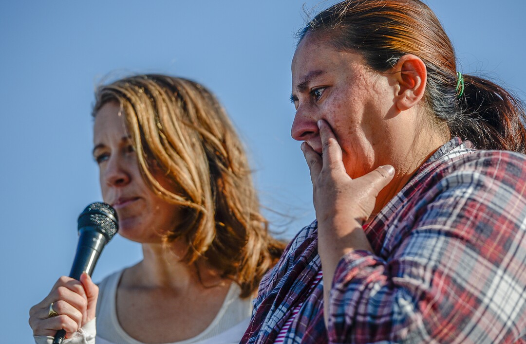 (Francisco Kjolseth  |  The Salt Lake Tribune)  Activist Kate Savage translated for Maria Santiago Garcia as she relays her story of leaving violence and abuse in her native Guatemala 14 years ago only to face an impending deportation order. Community members gathered to rally in front of the Immigration and Customs Enforcement offices in West Valley City on Monday, Oct. 16, 2017, to support the single Utah mother of four U.S. born children who faces an impending deportation order.