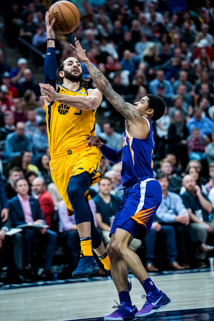 (Chris Detrick  |  The Salt Lake Tribune)  Utah Jazz guard Ricky Rubio (3) passes around Phoenix Suns guard Tyler Ulis (8) during the game at Vivint Smart Home Arena Thursday, March 15, 2018.  Utah Jazz defeated Phoenix Suns 116-88.