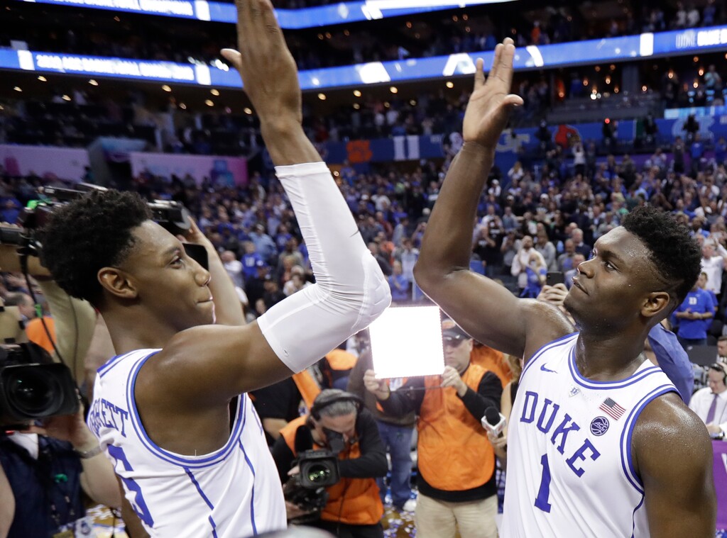 Duke's RJ Barrett (5) and Zion Williamson (1) celebrate after defeating Florida State in the NCAA college basketball championship game of the Atlantic Coast Conference tournament in Charlotte, N.C., Saturday, March 16, 2019. (AP Photo/Chuck Burton)
