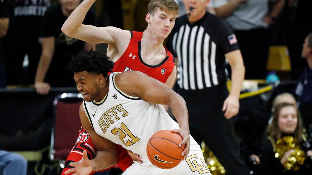 Colorado forward Evan Battey, front, drives to the basket as Utah center Branden Carlson defends in the first half of an NCAA college basketball game Sunday, Jan. 12, 2020, in Boulder, Colo. (AP Photo/David Zalubowski)