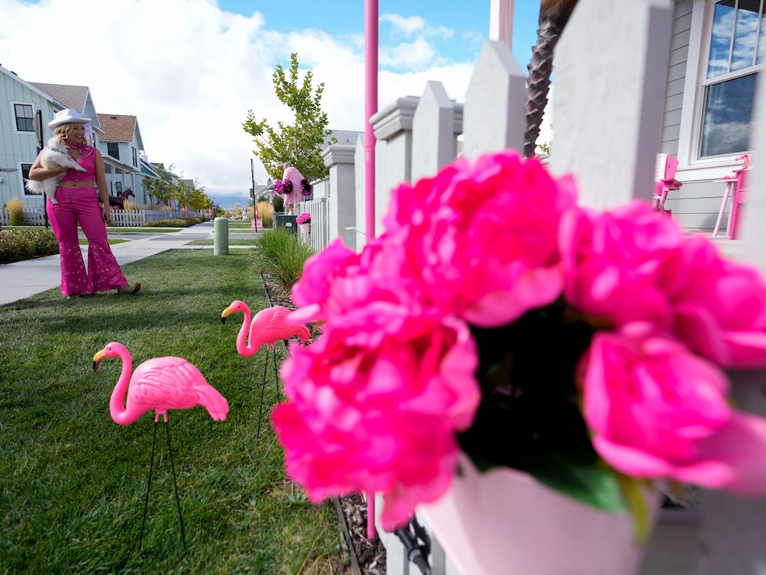 (Bethany Baker  |  The Salt Lake Tribune) Jamie Tucker, dressed as “Classic Barbie” from the movie “Barbie,” stands in front of her decorated home in a section of Daybreak that has collectively created a Barbieland-themed community for Halloween on Wednesday, Oct. 11, 2023.