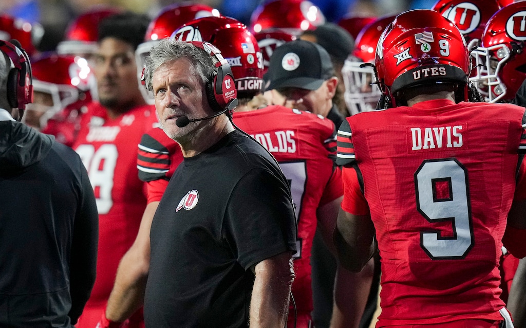 (Bethany Baker  |  The Salt Lake Tribune) Former Utah Utes head coach Kyle Whittingham stands on the sidelines during the game in 2025. The U. will pay Whittingham $13.5 million over the next three years.