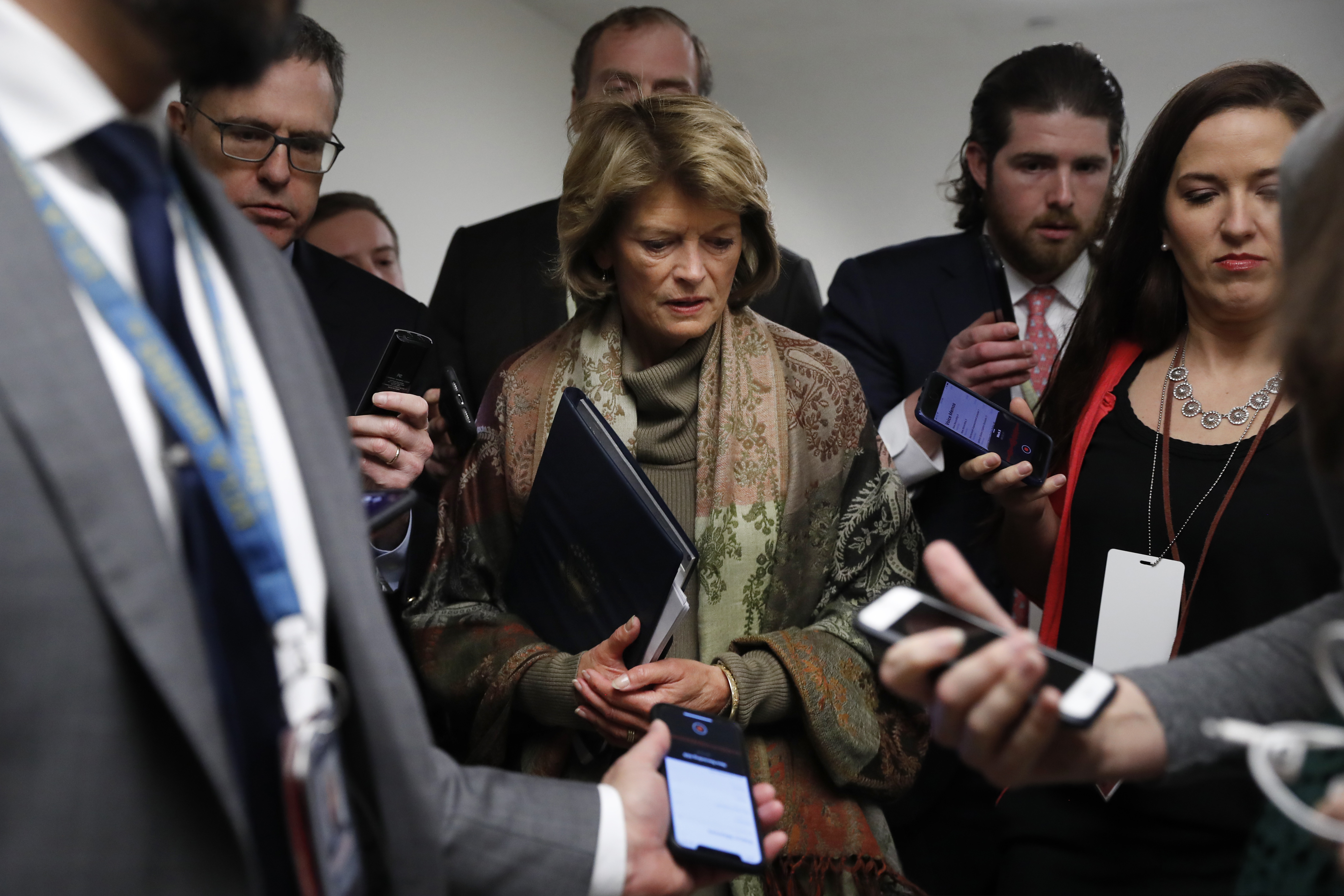 (Jacquelyn Martin | AP) Sen. Lisa Murkowski, R-Alaska, declines to answer questions from reporters as she walks, Wednesday, Jan. 22, 2020, on Capitol Hill in Washington. The U.S. Senate has begun hearing opening arguments in President Donald Trump’s impeachment trial with proceedings now on a fast track.