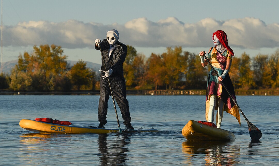 (Francisco Kjolseth  |  The Salt Lake Tribune)  Stand up paddle board enthusiasts Chris Knoles and Roxy Christensen take to the water at Bountiful Pond on Tuesday, Oct. 30, 2018, in what has become a Halloween tradition for the 4th year in a row as they dress up this year as Jack and Sally Skellington from the movie Nightmare Before Christmas. "We paddle year round but actually paddle more in the winter," exclaimed Knoles, who carry the tradition on at Christmas, dressing up in something festive and paddling on the Great Salt Lake where the high salinity usually keeps the water from freezing.