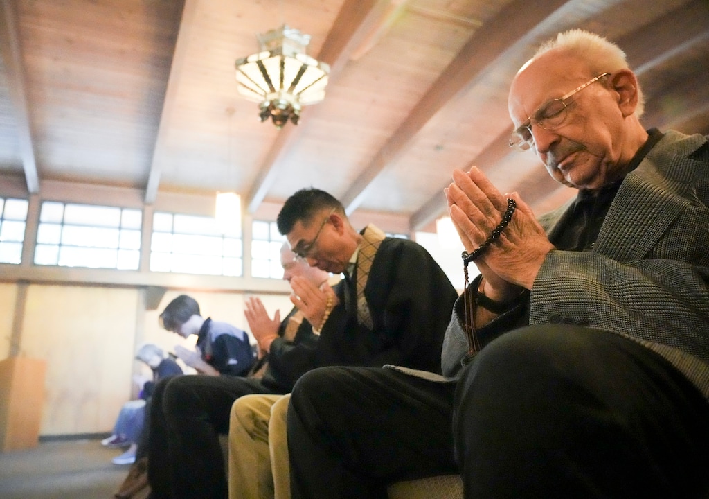 (Bethany Baker | The Salt Lake Tribune) Congregants perform the hand gesture gassho, bringing their hands together in gratitude, during the service at the Salt Lake Buddhist Temple in Salt Lake City on Sunday, Sept. 22, 2024. The temple is one of two faith institutions that fall within the confines of the planned sports district currently moving through the approval process.