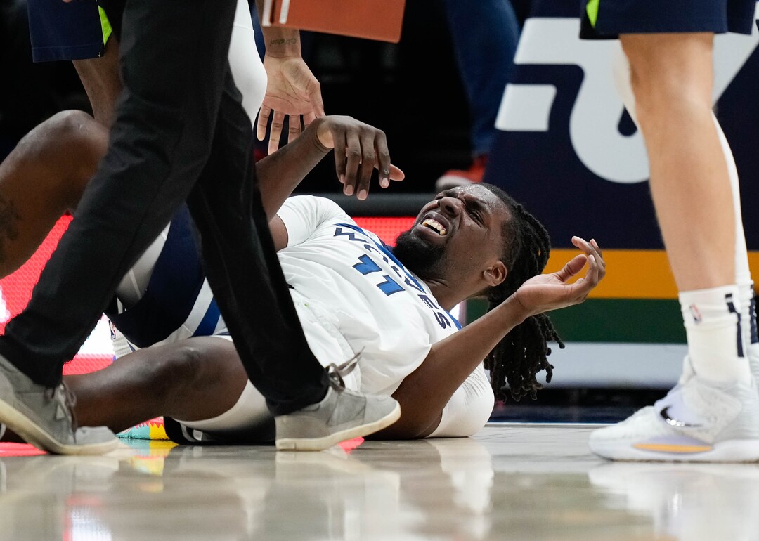 (Francisco Kjolseth | The Salt Lake Tribune) Utah Jazz guard Mike Conley (11) takes a hard hit from Utah Jazz center Rudy Gobert (27) who draws the fowl in NBA action between the Utah Jazz and the Minnesota Timberwolves at Vivint Smart Home Arena in Salt Lake City, Thursday, Dec. 23, 2021.