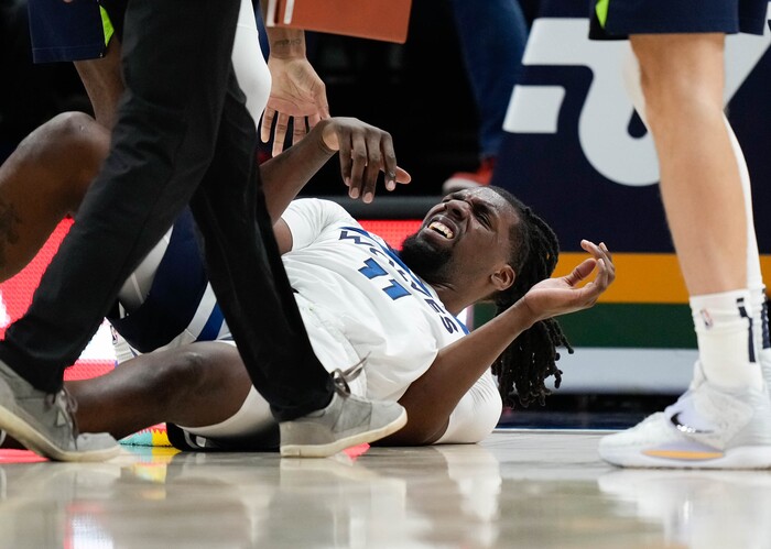 (Francisco Kjolseth | The Salt Lake Tribune) Utah Jazz guard Mike Conley (11) takes a hard hit from Utah Jazz center Rudy Gobert (27) who draws the fowl in NBA action between the Utah Jazz and the Minnesota Timberwolves at Vivint Smart Home Arena in Salt Lake City, Thursday, Dec. 23, 2021.