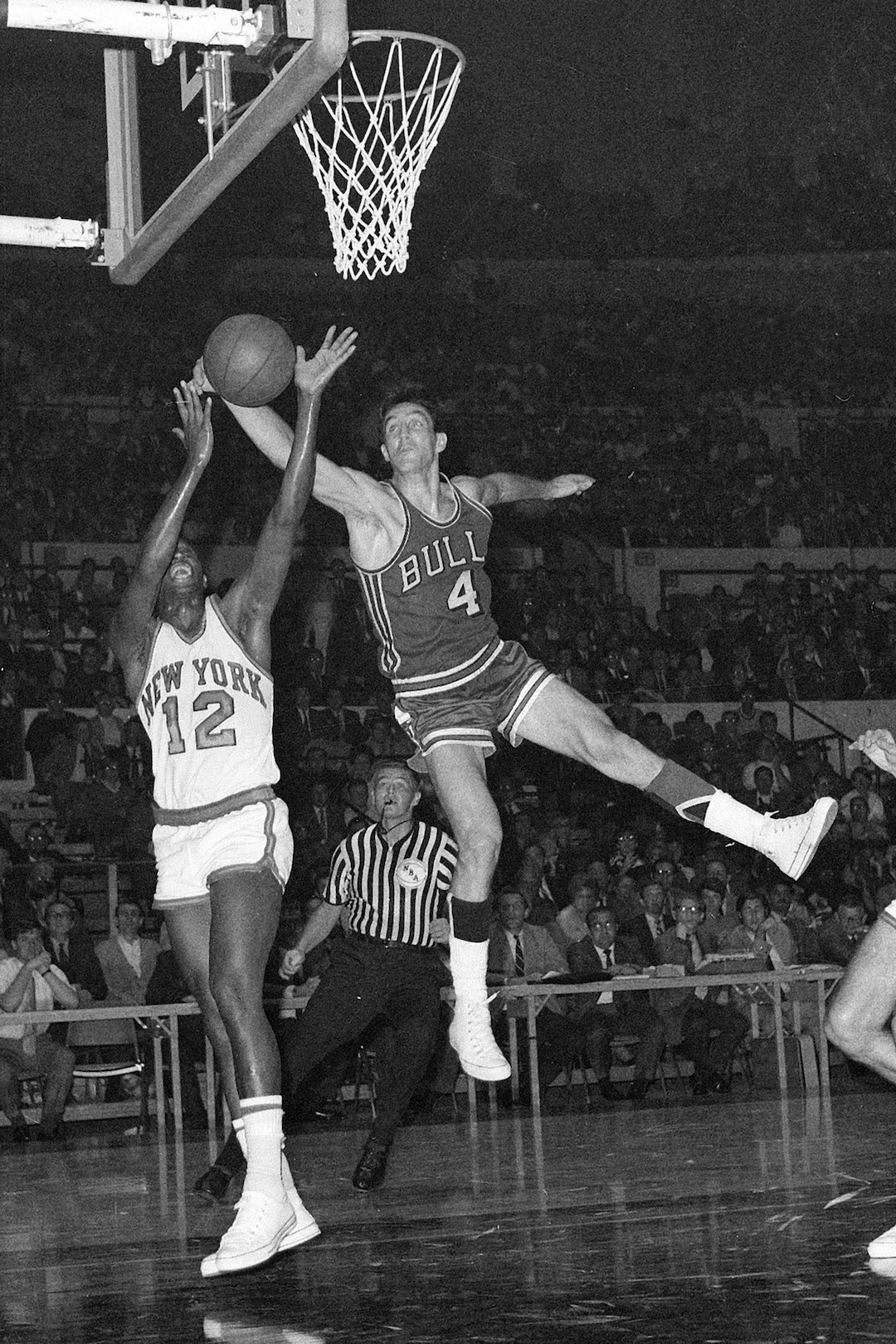 (Dave Pickoff  |  AP Photo) New York Knicks' Dick Barnett (12) and Chicago Bulls' Jerry Sloan (4) go after a rebound during third period of game at Madison Square Garden in New York City, Oct. 16, 1968.  In the background is referee Earl Strom.  Bulls won, 100-96.