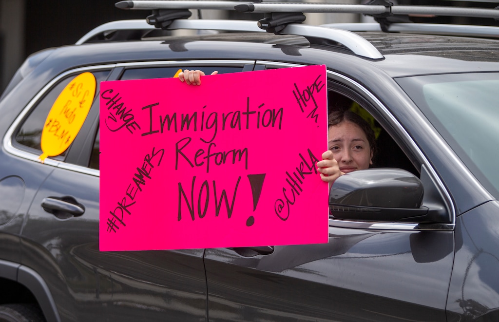 (Damian Dovarganes | AP photo)
A young student joins members of Coalition for Humane Immigrant Rights of Los Angeles, CHIRLA, on a vehicle caravan rally to support the Deferred Action for Childhood Arrivals Program DACA, around MacArthur Park in Los Angeles, Thursday, June 18, 2020.