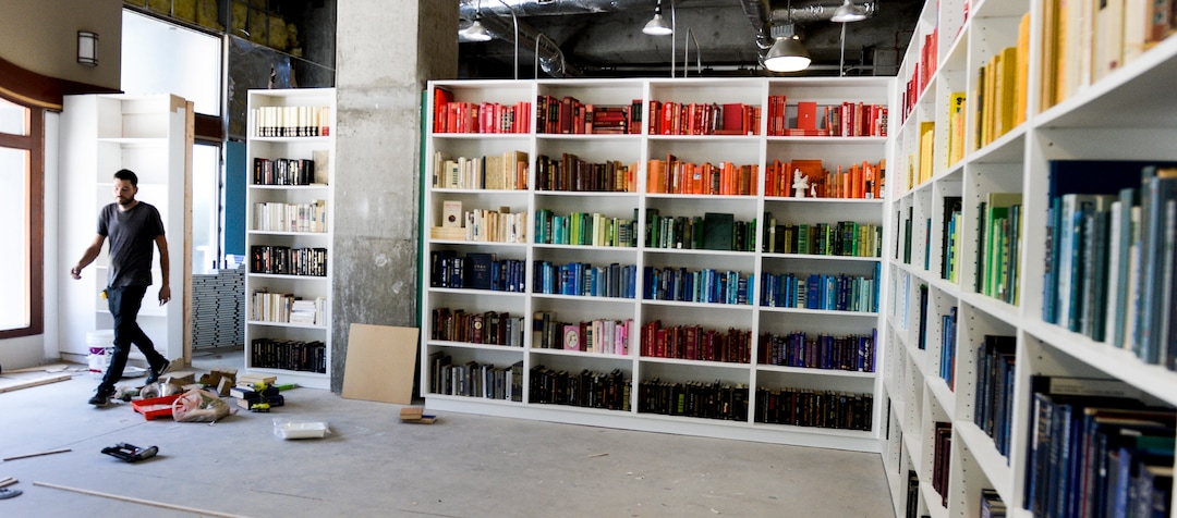 (Leah Hogsten  |  The Salt Lake Tribune) Co-designer and artist Josh Clason walks through an opening hidden by a hinged bookcase as part of the Love Letters Museum opening June 21, 2109. Love Letters is the newest 15,000-square-foot interactive art installation at The Gateway dedicated to the love of letters, as well as typography, books and literal love letters. “It is our attempt to use what we know best (letters, words, and art) to encourage each of our visitors to find and tell their own story. And to find the art in other's stories.” -Love Letters Museum. ​