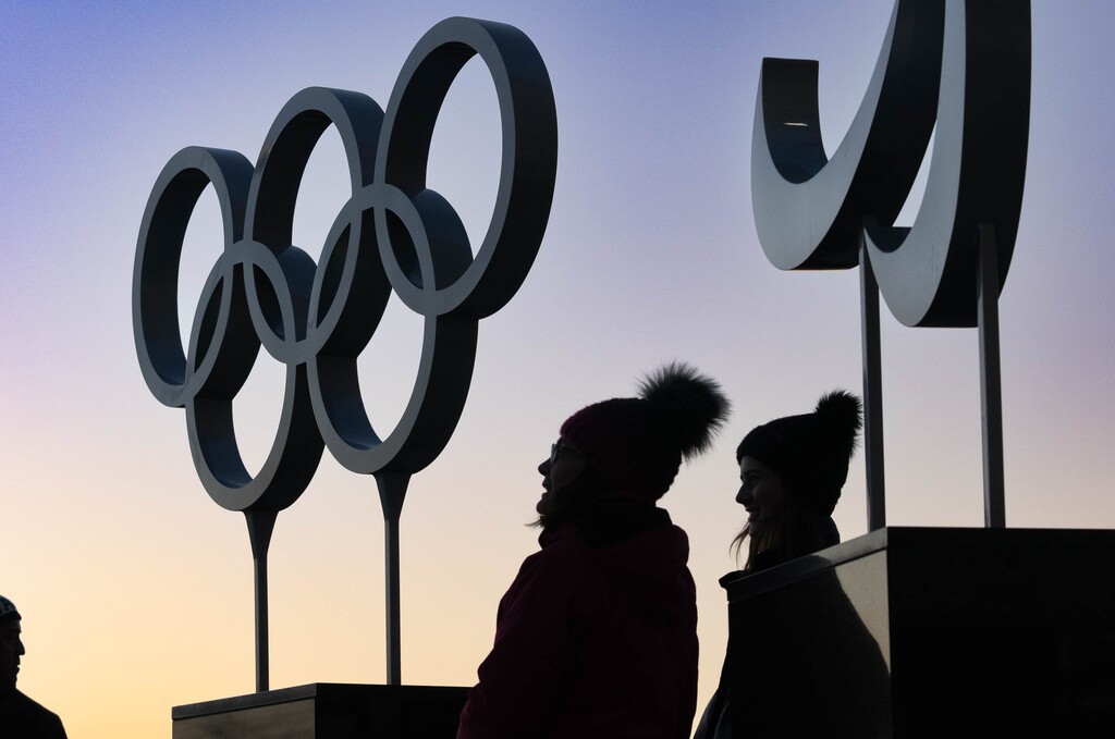 (Francisco Kjolseth | The Salt Lake Tribune) People gather near the Olympic cauldron before it is lit up on the 20-year anniversary of the Salt Lake 2002 Olympic Opening Ceremony at Rice-Eccles Stadium on Tuesday, Feb. 8, 2022.