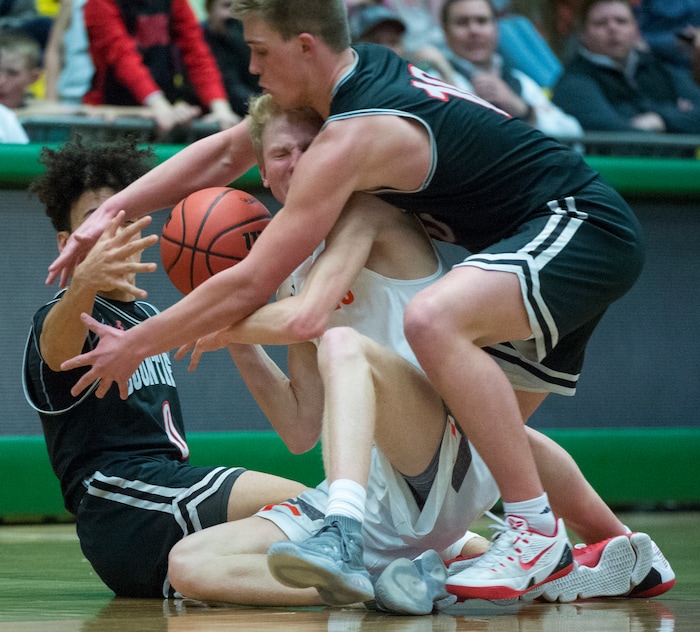 (Rick Egan  |  The Salt Lake Tribune)   Bountiful Braves Isaac Kime (0) and Bountiful Braves Brig Willard (10) go for the ball, as Skyridge Falcons Duncan Reid (3) tries to keep control of the ball in 5A basketball playoff action between the Bountiful Braves and Skyridge Falcons, at the UCCU Center in Orem, Monday, Feb. 26, 2018.