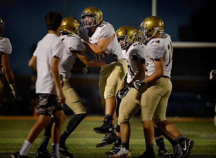 (Scott Sommerdorf   |  The Salt Lake Tribune)   
Skyline's Dax Lowe, center, celebrates with team mates after his interception stymied a Brighton drive late in the first half. Skyline held a 14-10 lead at the half over Brighton, Friday, September 15, 2017.