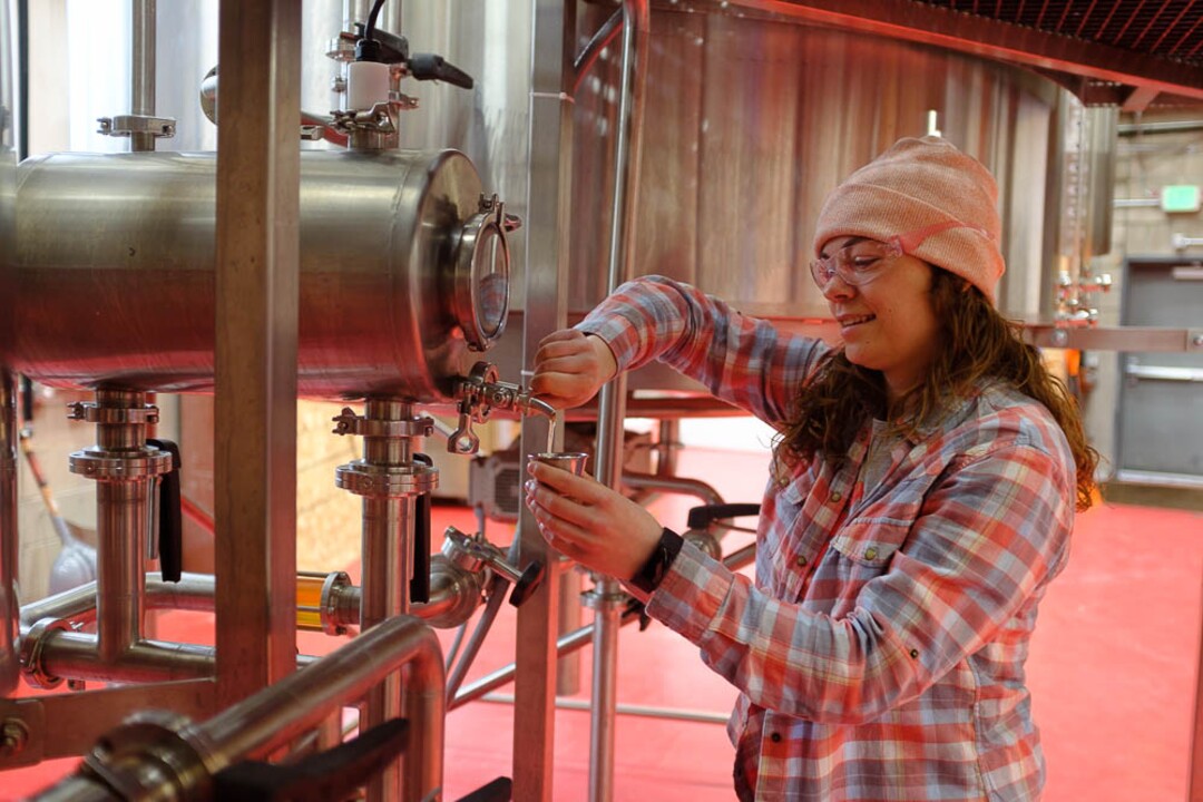(Trent Nelson | The Salt Lake Tribune)  
Lauren Lerch inspects the brew as top female brewers from across the state gathered at Roosters Brewing Co in Ogden on Friday March 8, 2019 — International Women's Day — to brew “On Wednesdays We Wear Pink Boots" Cold IPA.
