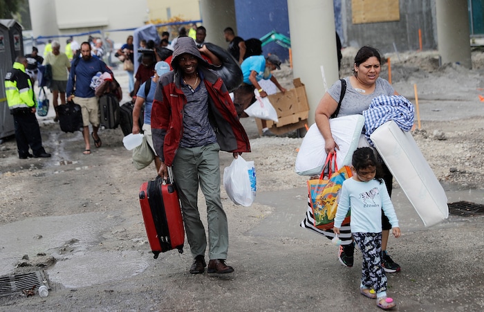 (AP Photo/David Goldman) Evacuees are moved to another building with more bathrooms while sheltering at Florida International University ahead of Hurricane Irma in Miami, Saturday, Sept. 9, 2017.