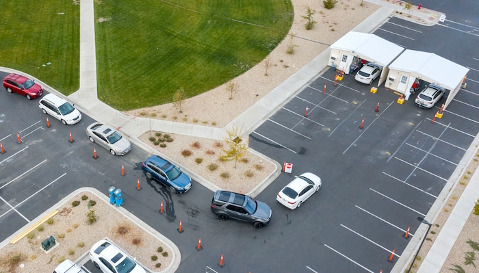 (Leah Hogsten  |  The Salt Lake Tribune) A line of cars bends around the University Of Utah Hospital's parking lot as people wait for COVID-19 testing in Farmington, Oct. 23, 2020.