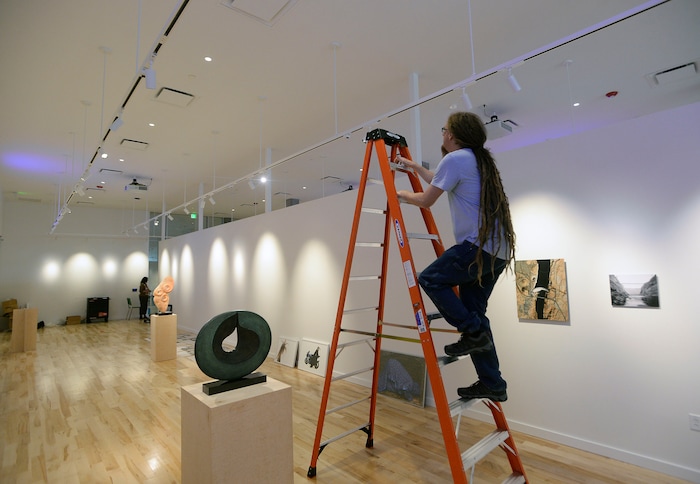 (Al Hartmann  |  The Salt Lake Tribune) 	
Utah State University is getting ready to reopen the renovated Chase Fine Arts Center, an arts complex that includes the totally remodeled Daines Concert Hall.  Scene shop-gallery technician Scott Richardson adjusts lighting in the new Tippetts Galleries for an upcoming art show.  