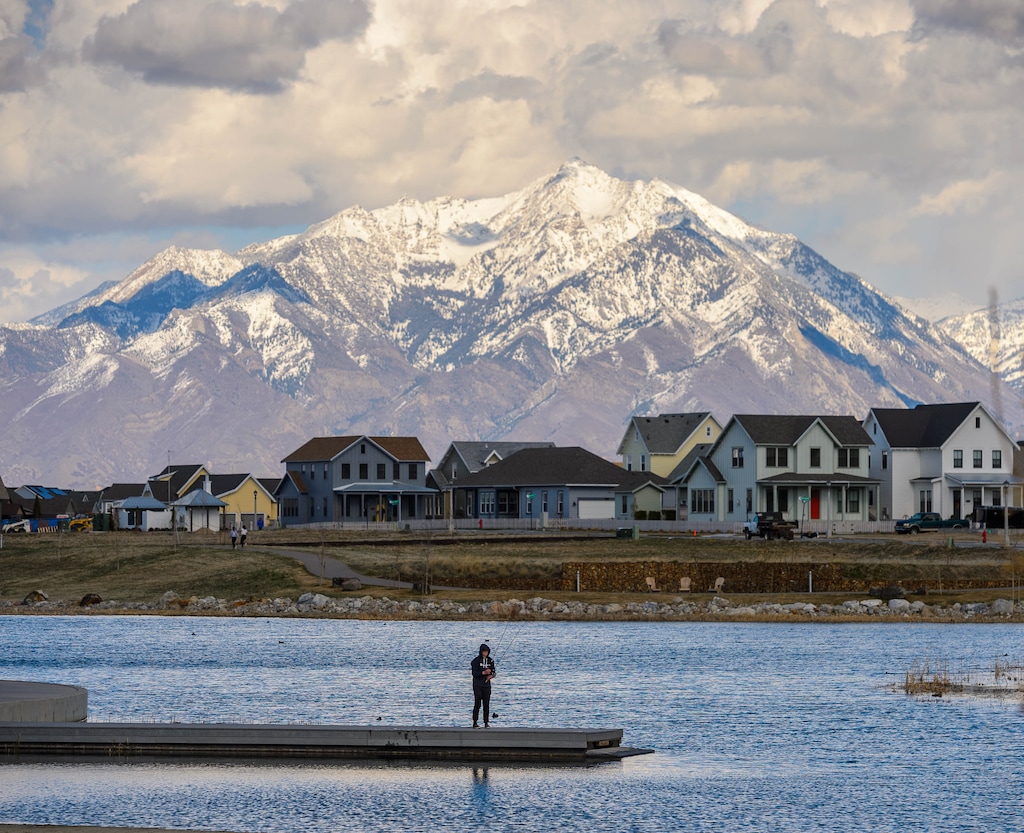 (Trent Nelson | Salt Lake Tribune file photo) A man fishing at Oquirrh Lake in Daybreak on Thursday, April 2, 2020. The Larry H. Miller Group of Cos. is buying a large piece of Daybreak.