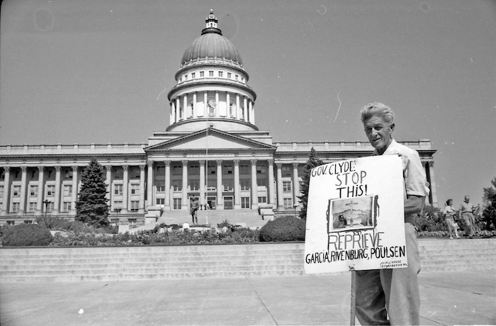 (photo courtesy Jerry Currier)  Ammon Hennacy pickets on behalf of three death row inmates at the State Capitol in 1961.