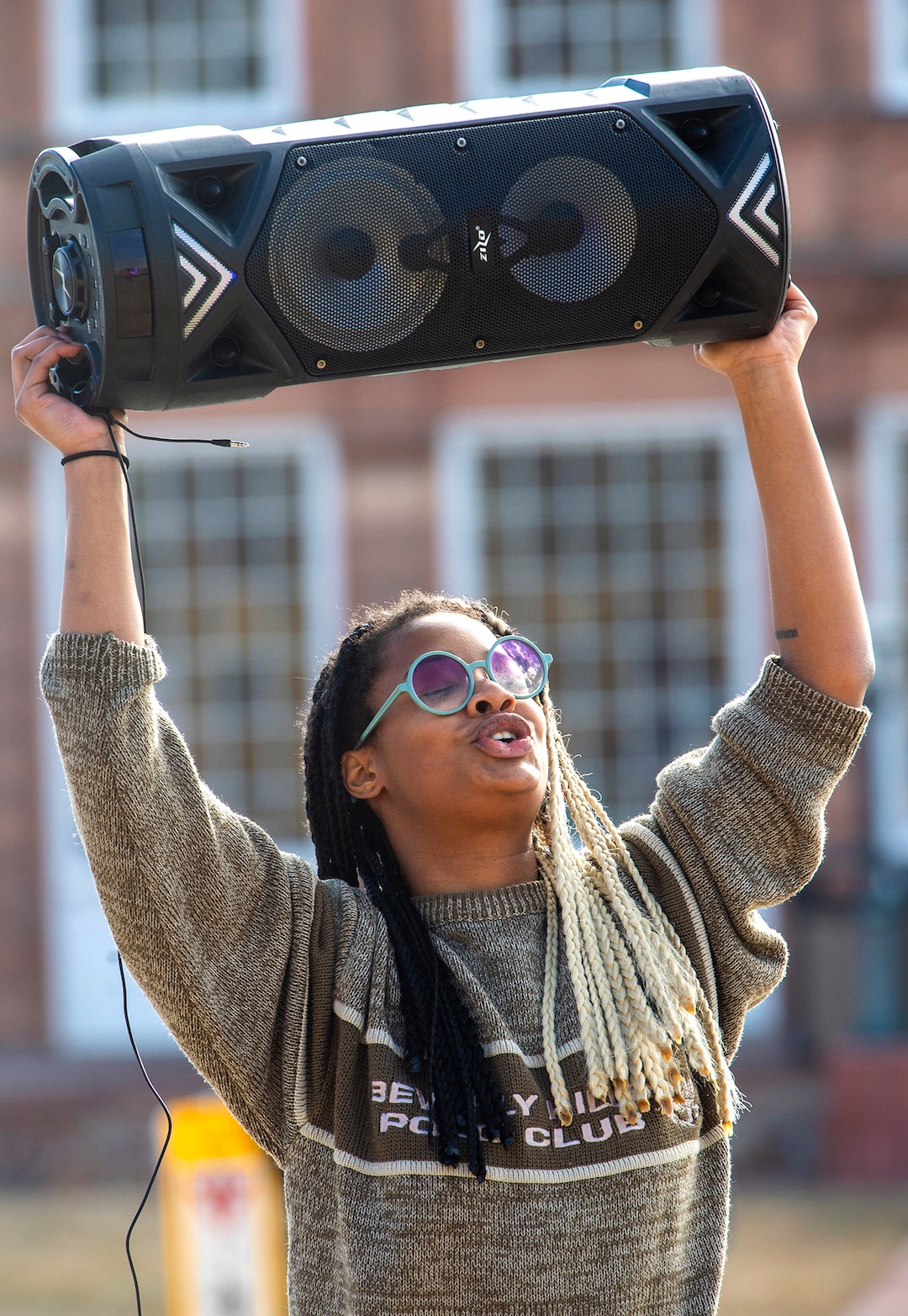 (Rick Egan | The Salt Lake Tribune) A woman holds a speaker as it plays a anti-President Donald Trump song during a small gathering of protesters at the Utah Capitol, on Sunday, Jan. 17, 2021.
