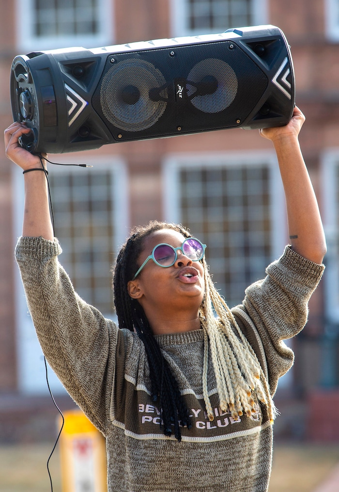(Rick Egan | The Salt Lake Tribune) A woman holds a speaker as it plays a anti-President Donald Trump song during a small gathering of protesters at the Utah Capitol, on Sunday, Jan. 17, 2021.