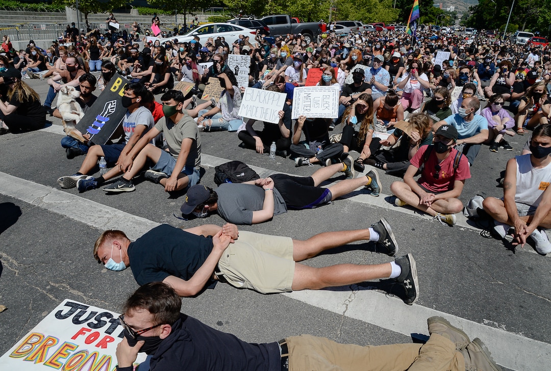 (Francisco Kjolseth  |  The Salt Lake Tribune) Demonstrators stop to protest outside the Salt Lake City Public Safety Building as part of a series of Juneteenth celebrations on Friday, June 19, 2020.