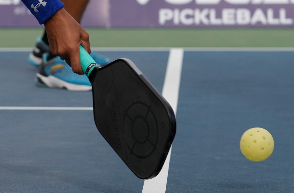 (Leah Hogsten | The Salt Lake Tribune)  Professional pickleball player Jessie Irvine returns a volley during the PPA Tournament of Champions in Brigham City, Thursday, Aug. 18, 2022.  Pickleball players must play behind a 7-foot no-volley zone on each side of the net and must let the ball bounce once before volleys are allowed.