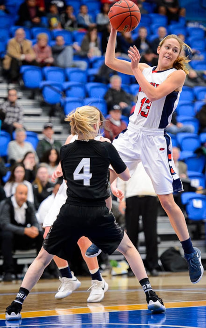 (Trent Nelson | The Salt Lake Tribune)  Woods Cross's Sara Noel (13) passes over Highland's Olivia Beckstead (4)  as Woods Cross faces Highland in the 5A High School Girls' Basketball Tournament at SLCC in Taylorsville, Wednesday Feb. 21, 2018.