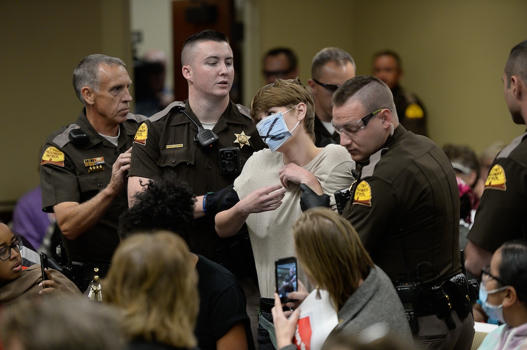 (Francisco Kjolseth  |  The Salt Lake Tribune)  Utah Highway Patrol troopers remove a woman blowing a whistle through a surgical mask as the Utah Inland Port Authority meets for the first time since its June meeting was disrupted by protestors at the Utah Capitol on Thursday, Oct. 17, 2019.